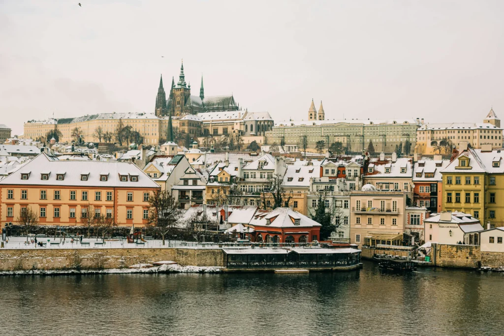 Snow-covered rooftops and Charles Bridge in Prague, Czech Republic showcasing the beauty of Europe in winter
