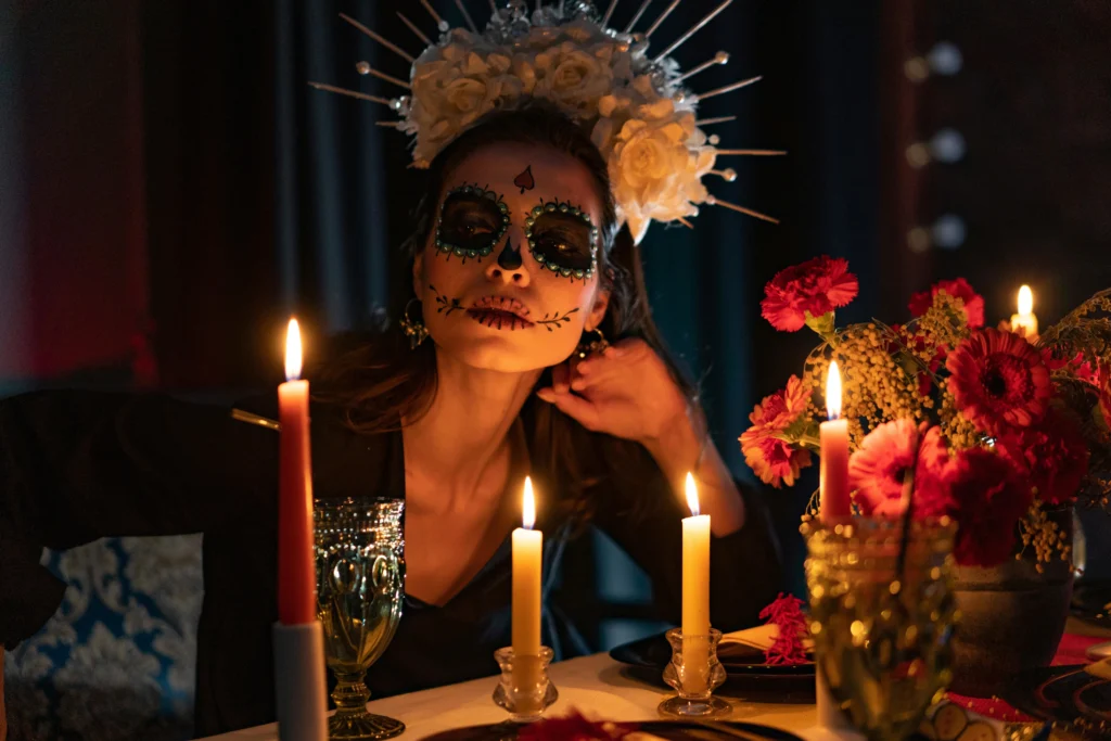 Traditional Día de los Muertos altar in Mexico decorated with marigold flowers, candles, ahonoring loved ones.