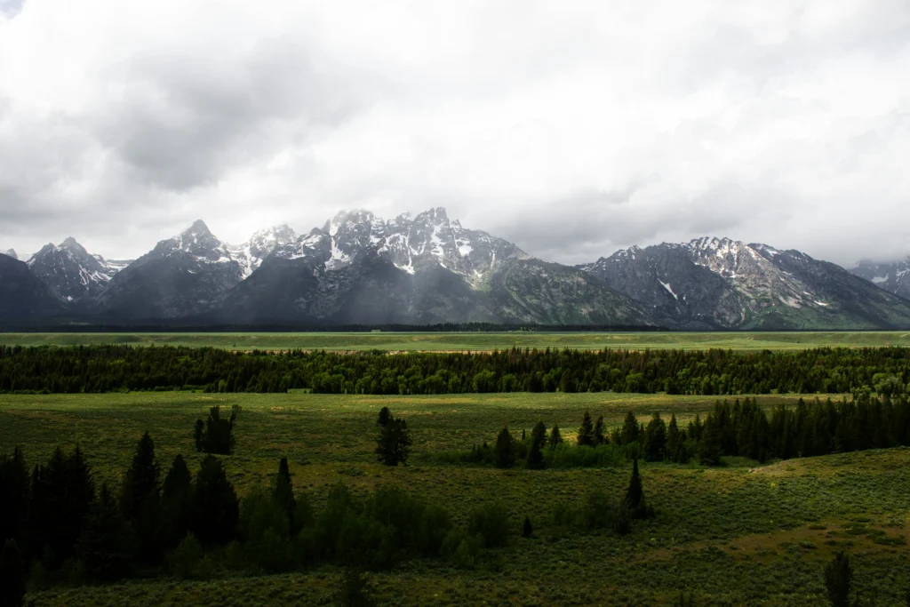 Snowy Grand Tetons view in Jackson Hole Wyoming with cozy mountain lodges
