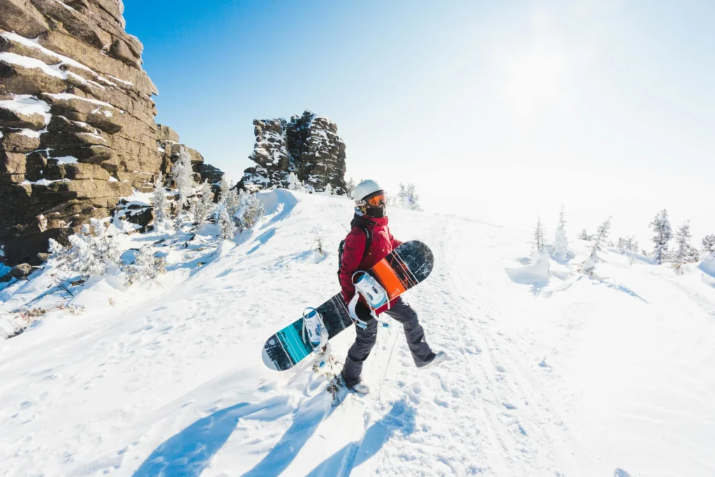 Skiers and snowboarders descending snowy slopes in the Rocky Mountains during winter in the USA