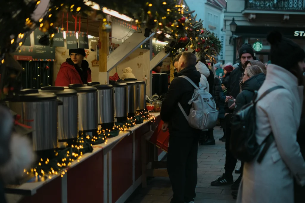 Crowds enjoying colorful lights and holiday stalls at a winter festival in Chicago